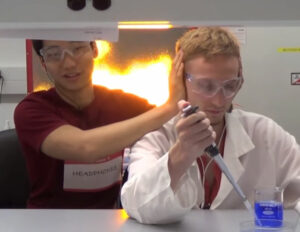 Student at Cornell demonstrating what happens when you can't hear during a lab emergency